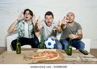 Group Of Friends Fanatic Football Fans Watching Soccer Game On Television With Beer Bottles And Pizza Suffering Stress And Crazy Nervous On Couch Screaming And Complaining