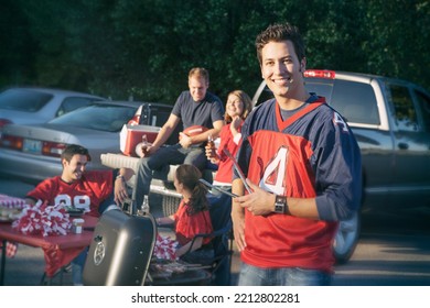 Group of friends at a football tailgating party outside.