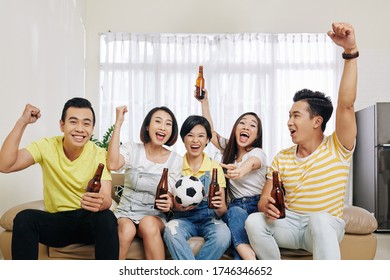 Group Of Friends Gathered At Home To Drink Some Beer And Watch Soccer Game Online