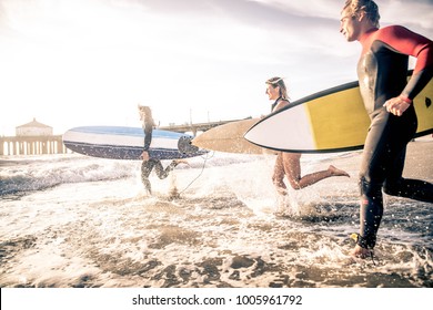 Group of friends going to surf at the beach - Powered by Shutterstock