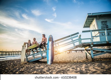 Group of friends going to surf at the beach - Young adults bonding at the beach - Powered by Shutterstock