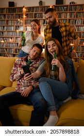 Group Of Friends Hanging Together On A House Party Drinking Beer While Having Fun