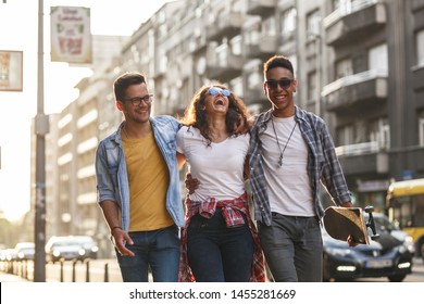 Group Of Friends Hangout At The City Street.They Embrace Each Other And Laughing.