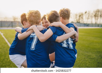 Group of friends happy kids in school sports team. Boys gathering and having fun on sports field. Cheerful children boys players of school soccer team. Happy boys in junior football team - Powered by Shutterstock