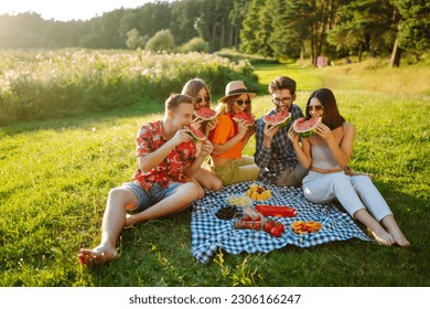 Group of friends  have fun together and eating watermelon in hot summer day. People, lifestyle, travel, nature and vacations concept.  - Powered by Shutterstock