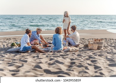 Group of friends having beac party on summer day. - Powered by Shutterstock