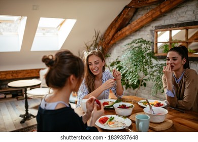 Group of friends having breakfast together in the morning at home - Powered by Shutterstock