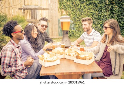 Group Of Friends Having Brunch Together. Sitting In The Garden And Drinking Beer. Burgers And Friets Are On The Table. Concept About Friendship