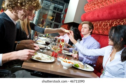 A Group Of Friends Having Dinner At A Restaurant