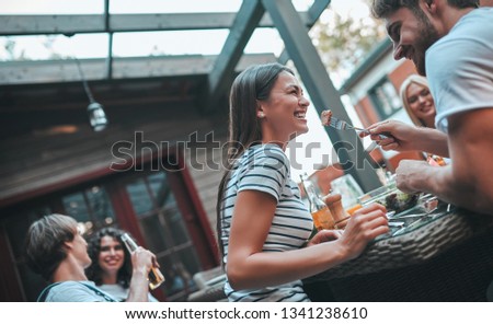 Similar – Woman holding lemonade glass and friends cooking in barbecue