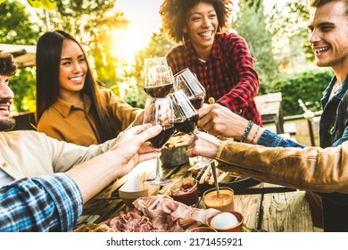 Group Of Friends Having Fun At Bbq Dinner In Garden Restaurant - Multiracial People Cheering Red Wine Sitting Outside At Bar Table - Social Gathering, Youth And Beverage Lifestyle Concept
