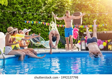 Group Of Friends Are Having Fun By The Pool. They Are Listening To Music Played By A DJ.