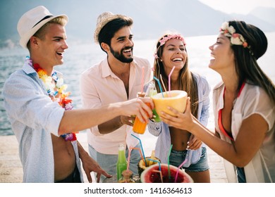 Group of friends having fun and dancing on the beach. Summer party on the beach