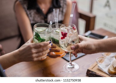 Group of friends having fun and drink cocktails. Cheers glasses in the hands. Summer mood in Minsk, Belarus.vk
