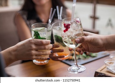 Group Of Friends Having Fun And Drink Cocktails. Cheers Glasses In The Hands. Summer Mood In Minsk, Belarus.