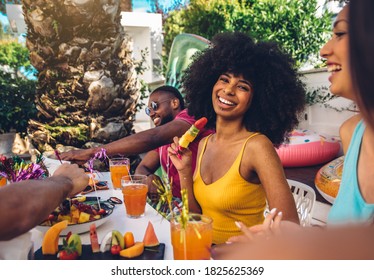 Group Friends Having Fun Drinking Cocktails Sitting In Villa Backyard - Happy Young Hispanic Woman Smiling At The Camera At Garden Party With Friends - Summer Lifestyle And Food Concept.