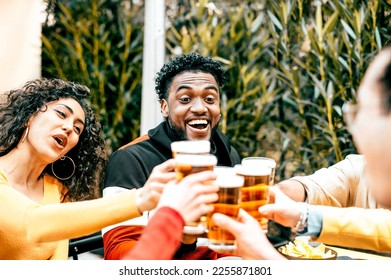 Group of friends having fun and drinking beer at bar restaurant - Multi ethnic people sitting at pub table toasting lager glasses in brewery garden - Happy hour party lifestyle concept	
 - Powered by Shutterstock