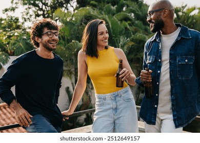 Group of friends having fun and drinking beer on a sunny weekend outdoors. Perfect summer vibes and casual relaxation. - Powered by Shutterstock