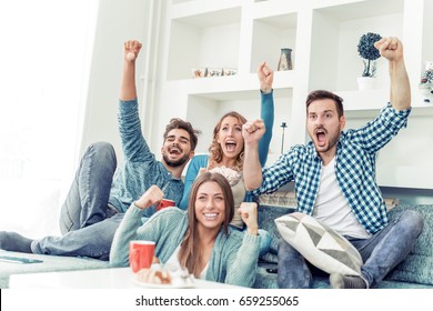 Group of friends having fun at home,watching game and enjoying together. - Powered by Shutterstock