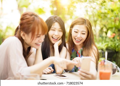 Group Of Friends Having Fun And Looking At Smart Phone
