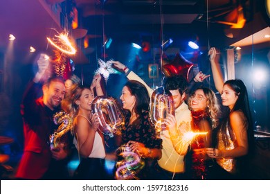 Group of friends having fun at New Year's party - Shutterstock ID 1597182316