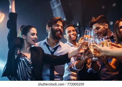 Group of friends having fun in the nightclub