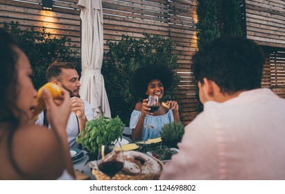 Group Of Friends Having Fun On The Rooftop Of A Beautiful Penthouse