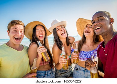 Group of friends having fun on the beach - Young and happy tourists bonding outdoors, enjoying summertime - Shutterstock ID 1653546229