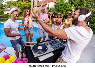 Group Of  Friends Having Fun On Vacation.Dj Mixing Outdoor At Pool Party.