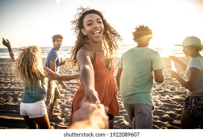 Group of friends having fun on the seashore - Powered by Shutterstock