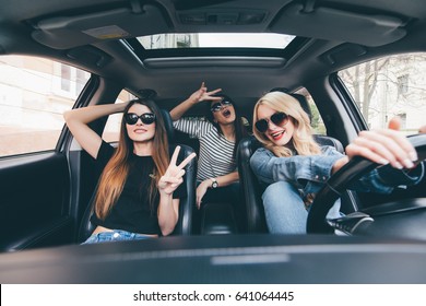 Group Of Friends Having Fun On The Car. Singing And Laughing In The City