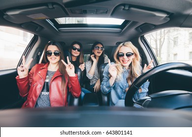 Group Of Friends Having Fun On The Car. Singing And Laughing In The City Center