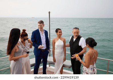 group of friends having fun and party celebrating on luxury yacht - Powered by Shutterstock