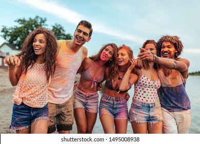 Group of friends having fun with powder paint outdoors - Shutterstock ID 1495008938