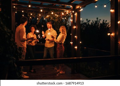 Group Of Friends Having Fun With Sparklers At The Terrace Party