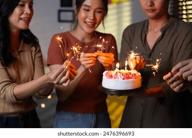 group of friends having fun with sparklers dancing confetti. celebrating Birthday party. Group of friends smiling enjoying party - Powered by Shutterstock