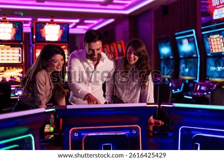 A group of friends having fun while playing games at a neon-lit casino. The vibrant atmosphere enhances the entertaining experience as they engage in friendly gaming activities.