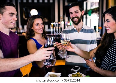 Group of friends having a glass of wine in a bar