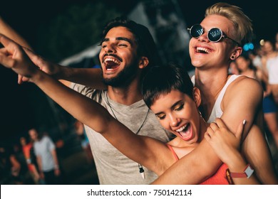 Group Of Friends Having Great Time On Music Festival