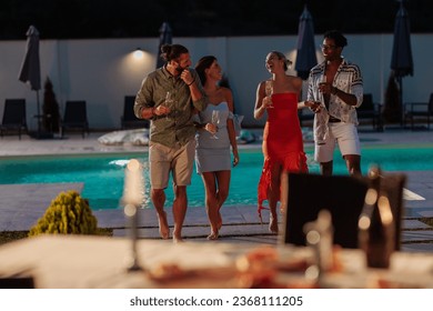 Group of friends having a night dinner party while drinking and having a great time by the pool side wearing formal wear - Powered by Shutterstock