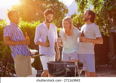 group of friends having outdoor garden barbecue laughing with alcoholic beer drinks - Shutterstock ID 271163843