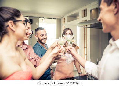 Group Of Friends Having Party At Home And Toasting Cocktail Glasses