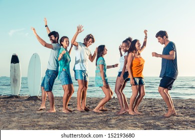 Group Of Friends Having A Party On The Beach