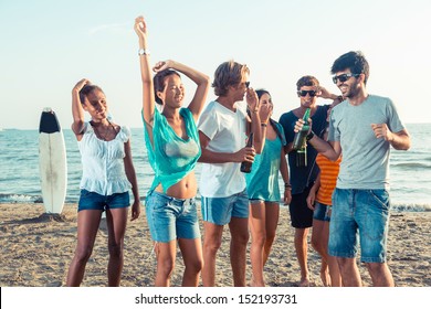 Group of Friends Having a Party on the Beach - Powered by Shutterstock