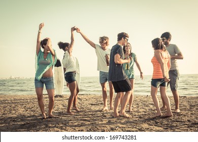 Group Of Friends Having A Party On The Beach