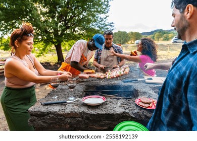 Group friends having party outdoors, focus on barbecue grill with food – multigeneration family grilling outside on backyard in garden party – group of multiracial diverse people having fun barbecuing - Powered by Shutterstock