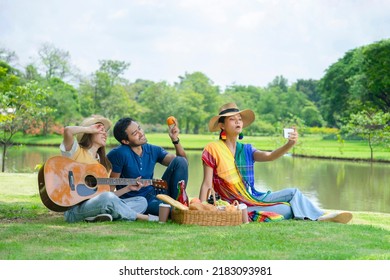 Group Of  Friends Having Picnic Together In The Park, Happy Asian People Doing Selfie Joyfully On Vacation. Concept Of People Lifestyle,life, Relaxing,vacation