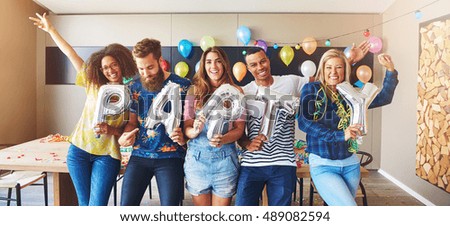 Holding silver balloon letters spelling love
