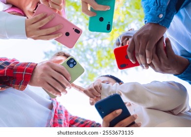  Group of friends holding different smartphones together, showing connection 