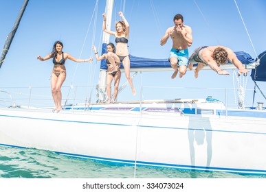 Group of friends jumping from the boat. having fun on the yacht and in the water. hot summer day and private boat party
